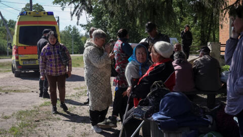 Residents from Vovchansk and nearby villages wait for evacuation to Kharkiv due to Russian shelling near the town of Vovchansk in Ukraine's Kharkiv region, on May 10, 2024.