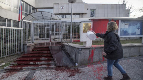 An activist pours red paint on the stairs of the Russian Embassy in Prague on early March 26, 2022. The Czech Republic was one of four countries to expel Russian diplomats on Tuesday.