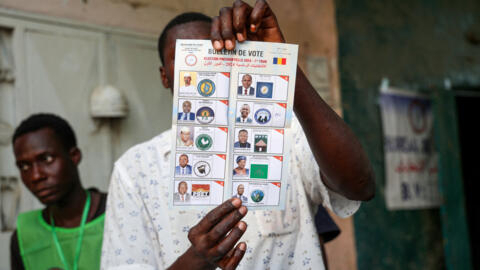 A file photo shows a poll worker holding a ballot during vote counting at a polling station during presidential election in N'Djamena, Chad on May 6, 2024.