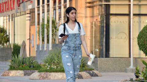 Saudi Manahel al-Otaibi, a 25-year-old activist, walks in western clothes in the Saudi capital Riyadh's al Tahliya street on September 2, 2019. 