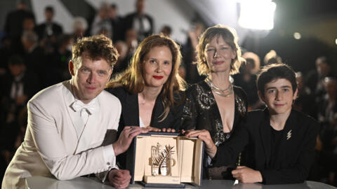 French director Justine Triet (second from left) poses with the cast of "Anatomy of a Fall" after winning the Palme d'Or at the Cannes Film Festival on May 27, 2023.