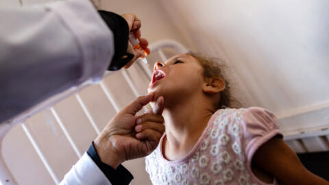 A nurse administers polio vaccine drops to a Palestinian girl at Nasser Hospital in Khan Younis, southern Gaza Strip, August 31, 2024.