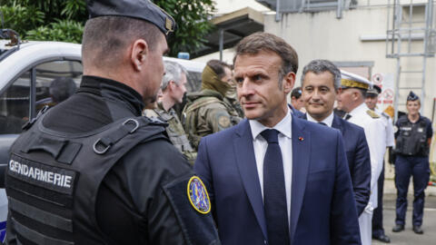 French President Emmanuel Macron visits the central police station with France's Minister for Interior and Overseas Gérald Darmanin in Noumea, France's Pacific territory of New Caledonia on May 23, 20