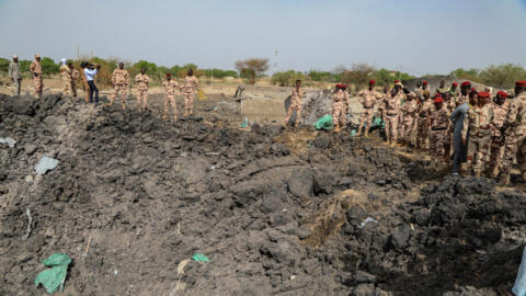 Army officers survey the damage caused by a fire that ripped through a military ammunition depot in N'Djamena, Chad, on June 19, 2024.