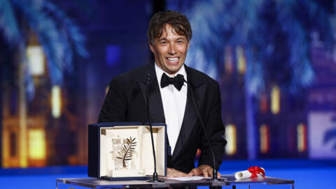 Director Sean Baker accepts his Palme d'Or for "Anora" at the closing ceremony of the 77th Cannes Film Festival on May 25, 2024.