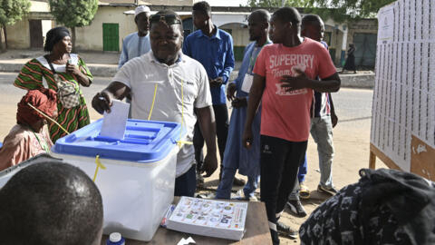 A voter casts his ballot at a polling station in N'Djamena on May 6, 2024 during Chad's presidential election.