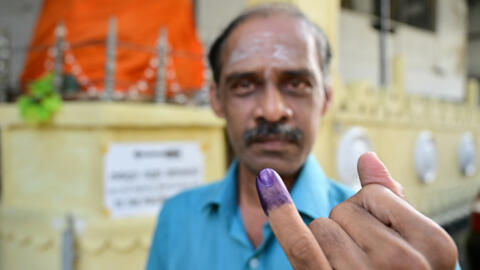 A voter shows his purple-marked finger after casting his vote in the presidential elections on 21 September 2024 in Colombo, Sri Lanka.