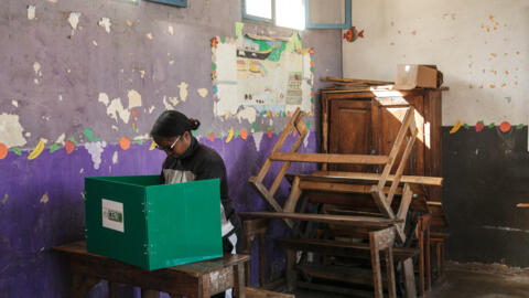 Une électrice prépare son bulletin de vote dans l'isoloir du bureau de vote d'Anosibe, dans le 4e arrondissement d'Antananarivo, le 29 mai 2024, lors des élections législatives.