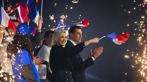 French far-right National Rally party leader Marine Le Pen, centre and president Jordan Bardella salute supporters at a meeting in Marseille, southern France, Sunday, March 3, 2024. (AP Photo/Daniel C