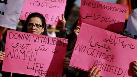 Manifestantes seguram cartazes enquanto participam de uma manifestação do Dia Internacional da Mulher, em Roma. Elas fazem greve para exigir o fim da violência doméstica e racista, das guerras e da cultura "machista" predominante no país. 8/03/2024.