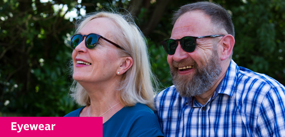 A white man and white woman wearing eyeshields outside