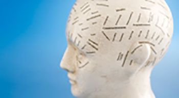 A mannequin head with black etchings