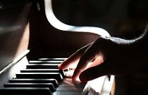 A musician plays the piano