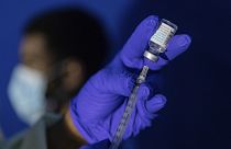 A family nurse practitioner prepares a syringe with the Mpox vaccine.