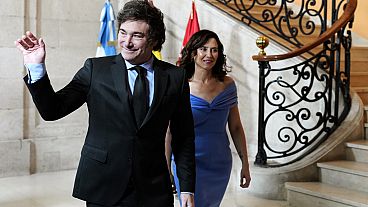 Argentine President Javier Milei waves next to Madrid's regional president, Isabel Díaz Ayuso, during their meeting in Madrid, Spain, Friday, June 21, 2024. 