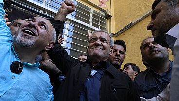 Reformist candidate for the Iran's presidential election Masoud Pezeshkian clenches his fist after casting his vote.