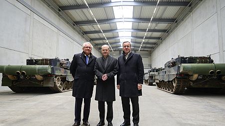 FILE - Armin Papperger, from left, CEO of Rheinmetall, German Chancellor Olaf Scholz and Boris Pistorius, German Minister of Defense, stand in a hall with Leopard 2A4 main bat