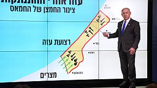 Israeli Prime Minister Benjamin Netanyahu stands before a map of the Gaza Strip, explaining how Hamas has imported arms into the territory since Israel's withdrawal in 2005.