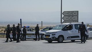 Israeli police stand guard near the site of a deadly shooting attack where Israeli officials say three people were shot and killed at the Allenby Bridge Crossing.