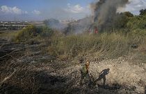 A police officer inspects a fire after the military said it fired interceptors at a missile launched from Yemen that landed in central Israel on Sunday, Sept. 15th 2024