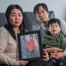 Melbourne professional Lily Lumintang (left) holds a picture of her disabled son, Jonathan, who is with family in Indonesia.