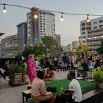 Visitors and artists gathering on Trames Agency’s rooftop in downtown Dakar, Senegal, during OFF, a smorgasbord of exhibitions and parties that is going on despite the absence of the official biennale.