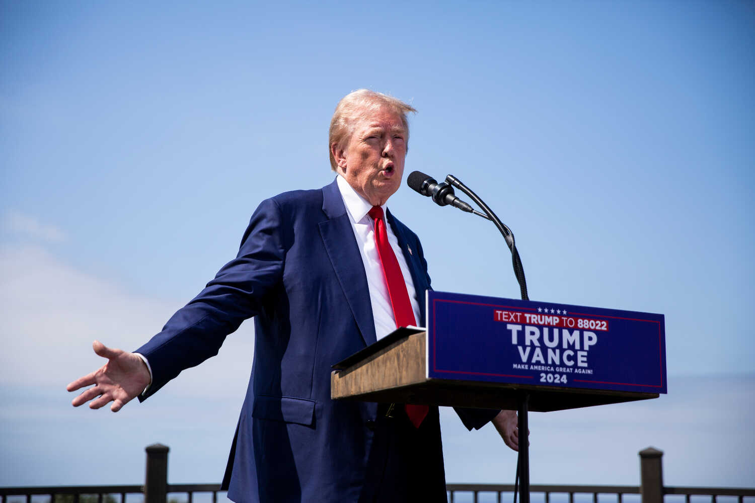 Former President Donald J. Trump attributed Sunday’s apparent assassination attempt against him to President Biden and Vice President Kamala Harris, arguing that the arrested suspect was acting in response to their attacks on him.