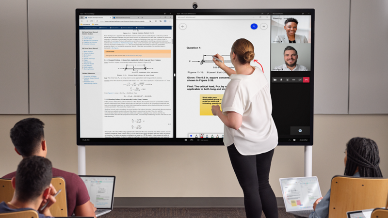 一名老師站在教室前方，用淺灰色 Surface 手寫筆在 Hub 85 吋上書寫。 Edge Whiteboard 和 Teams 在螢幕上顯示。 在前景中，數名學生擁有 Pro 7+ 且正在 One Note 中做筆記。