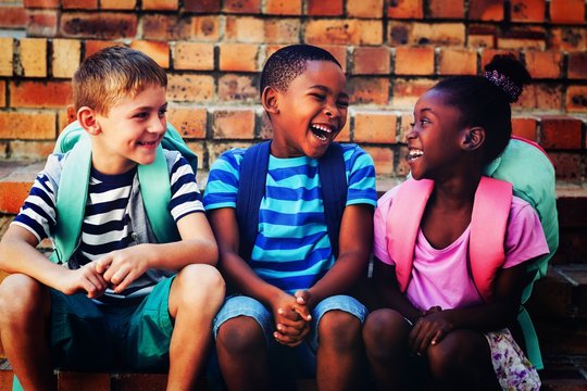 Happy children sitting on steps