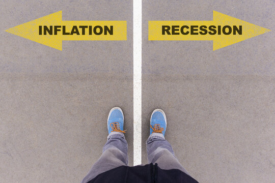 Inflation or recession choice, text on asphalt ground, feet and shoes on floor