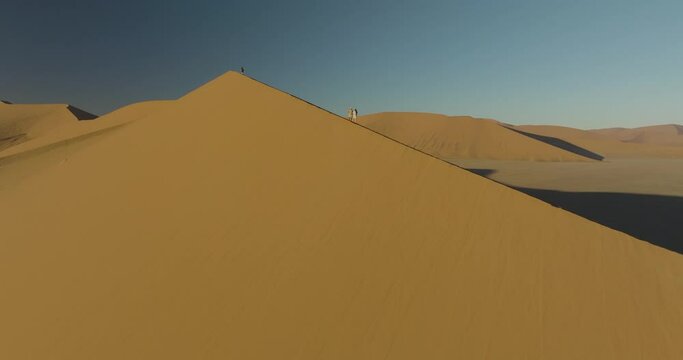 Aerial view of Sossusvlei and Deadvlei with sand dunes and people, Hardap, Namibia.