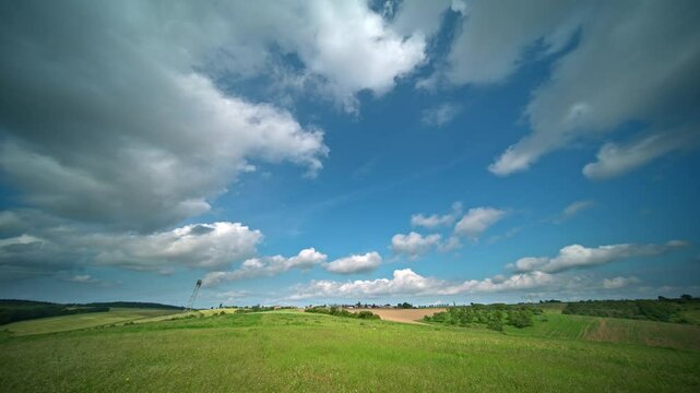 timelapse of summer clouds over a green meadow