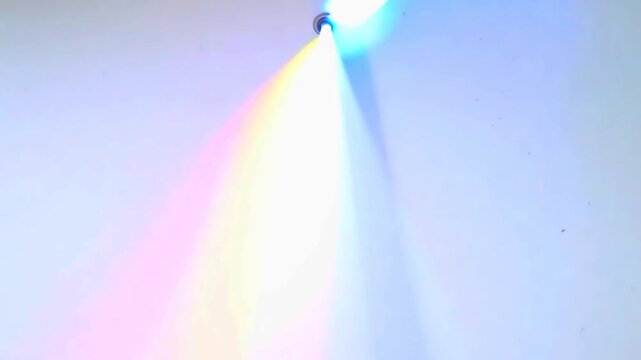 A clean, white background with brilliant light rays refracting through a prism, creating a spectrum of colors