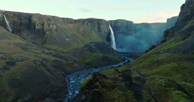 Man Standing On Cliff Overlooking Haifoss Waterfall In Canyon