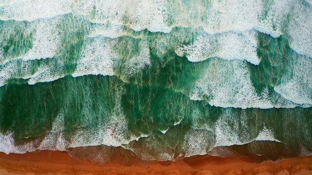 Aerial drone shot over the rocky coastline in Newquay, Cornwall, United Kingdom.
High view of the big waves coming to the shore. Destination for professional surfers.