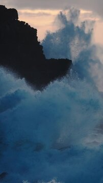 Extreme slow motion of beautiful ocean waves crashing into Kaiaka Rock, Molokai Hawaii suggests refreshment, beauty, inspiration, water, power, environmentalism and nature.