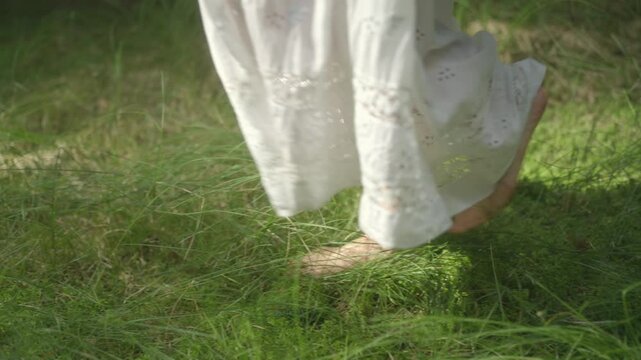 Barefoot she walks on morning dew, in a white dress, the world feels new