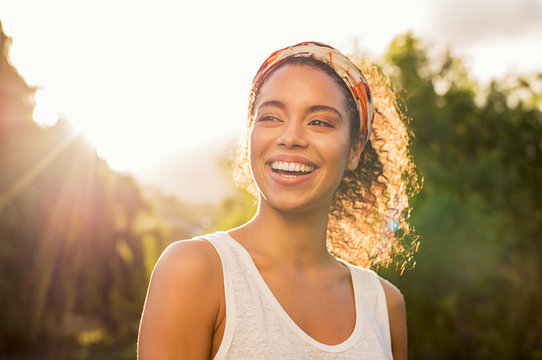 Young african woman smiling at sunset