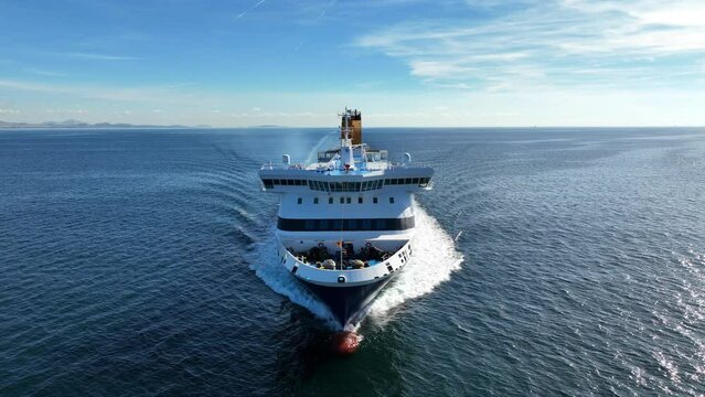 Aerial drone tracking video of passenger ferry bow cruising in high speed the Aegean deep blue sea