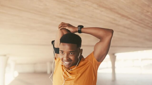 Black man, stretching arms and workout outdoor with earphones for music and running. Health, wellness and training, listening to radio for warm up and start fitness, athlete workout for sports