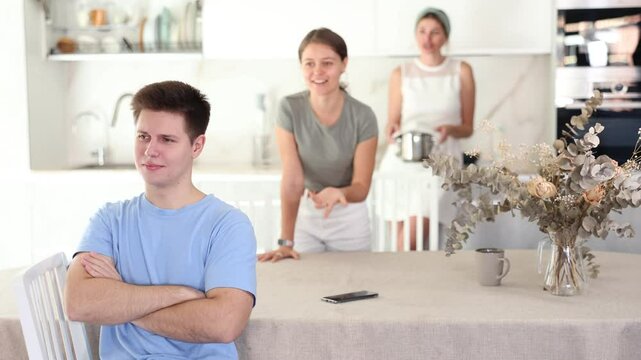 Upset guy dont speaking after discord with mother and young wife standing behind