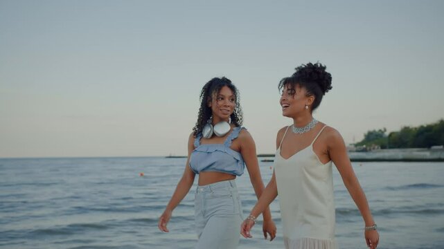 Black woman pointing at destination of promenade by sea