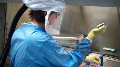 A scientist works at a biosafety level 4 lab.