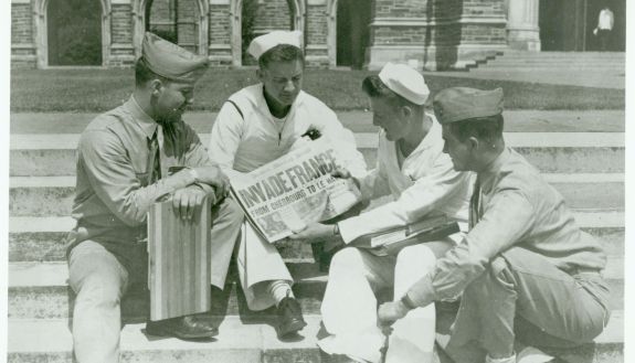 This photo was taken on D-Day—June 6, 1944—on the Duke Chapel steps as members of Duke’s Navy College Training Program read a headline about the Invasion of Normandy from the Durham Morning Herald newspaper. Courtesy Duke University Archives