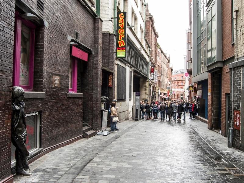 The famous Cavern Club a must visit in any Liverpool Travel Guide with statues of John Lennon in Mathew Street Liverpool