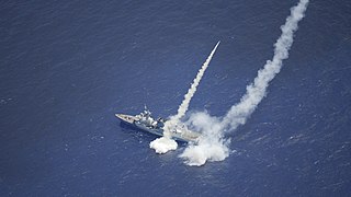 HMCS Regina fires Harpoon missiles