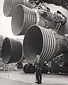 1969 English: Von Braun stands by the five F-1 engines of the Saturn V launch vehicle.