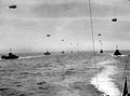 Convoys of ships on the open sea. Each has its observation balloon connected by a cable - June 1944