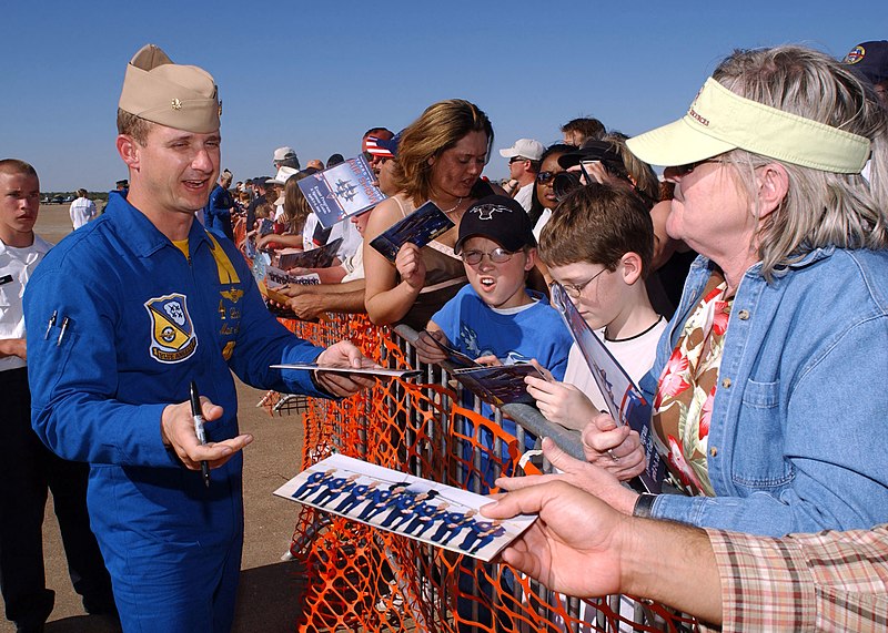 File:US Navy 050402-N-1328C-631 F-A-18A Hornet Slot Pilot, Lt. Cmdr. Max McCoy, assigned to the U.S. Navy flight demonstration team, the Blue Angels, signs autographs for fans during the Texas Thunder 2005 Air Show.jpg