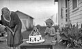 "Child_with_Snow_White_cake_1910-1940.jpg" by User:Tangerinehistry